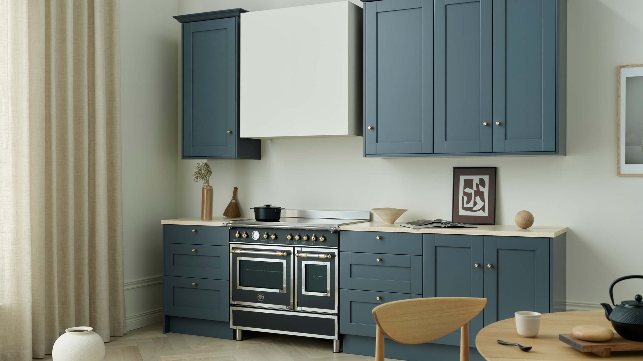 Klassiskt kök i blått med ljus bänkskiva i ask